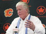 FILE - In this April 14, 2014, file photo, then-Calgary Flames' President of Hockey Operations and acting General manager Brian Burke speaks to the media in Calgary, Alberta. The uncertainty raised by coronavirus pandemic leads to experts providing a bleak short-term assessment on the NHL's financial bottom line, with some projecting revenues being cut by almost half. Former NHL executive-turned-broadcaster Brian Burke said the pain will be felt by teams and players alike. (AP Photo/The Canadian Press, Larry MacDougal, File)