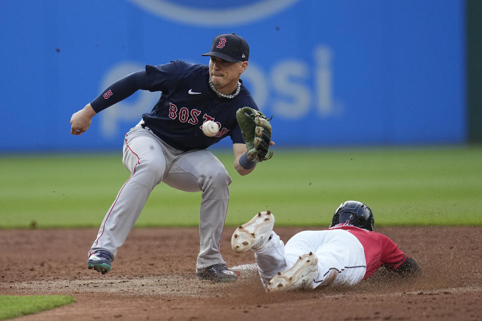 Boston Red Sox shortstop Enrique Hernandez, left, takes the throw in time to tag out Cleveland Guardians' Andres Gimenez, right, on an attempted steal of second base during the second inning of a baseball game Wednesday, June 7, 2023, in Cleveland. (AP Photo/Sue Ogrocki)