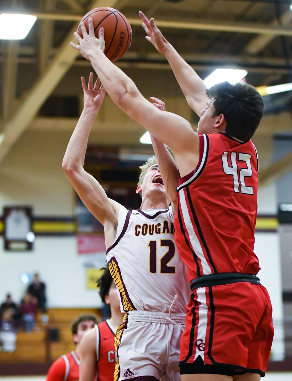 Center Grove’s Will Spellman (42) blocks a shot attempt from Bloomington North’s Connor O’Guinn (12) during the IHSAA boys’ basketball sectional semifinal game at Bloomington North on Friday, March 1, 2024.
