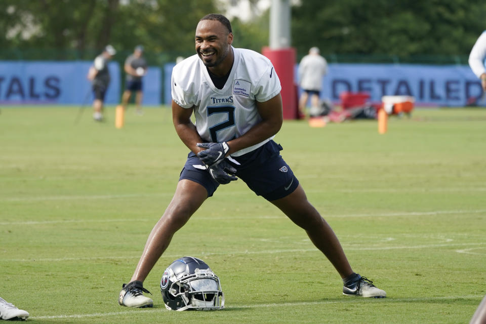 Tennessee Titans wide receiver Robert Woods stretches during training camp at the NFL football team's practice facility Saturday, July 30, 2022, in Nashville, Tenn. Both Woods and cornerback Caleb Farley have made impressive recoveries from the torn ACLs that ended the 2021 season for each. (AP Photo/Mark Humphrey)