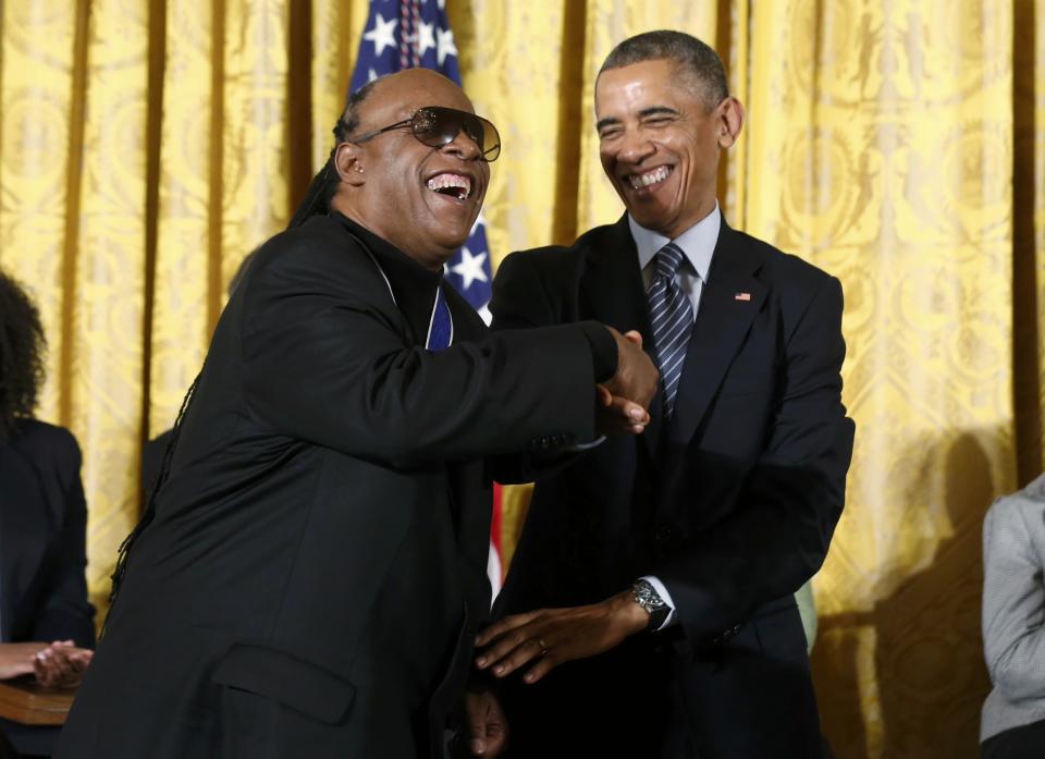 Singer Stevie Wonder (L) is greeted by U.S. President Barack Obama after receiving the Presidential Medal of Freedom during a White House ceremony in Washington, November 24, 2014. (REUTERS/Larry Downing)