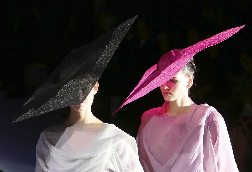 Models wear creations for Giorgio Armani women's Spring-Summer 2014 collection, part of the Milan Fashion Week, unveiled in Milan, Italy, Monday, Sept. 23, 2013. (AP Photo/Antonio Calanni)