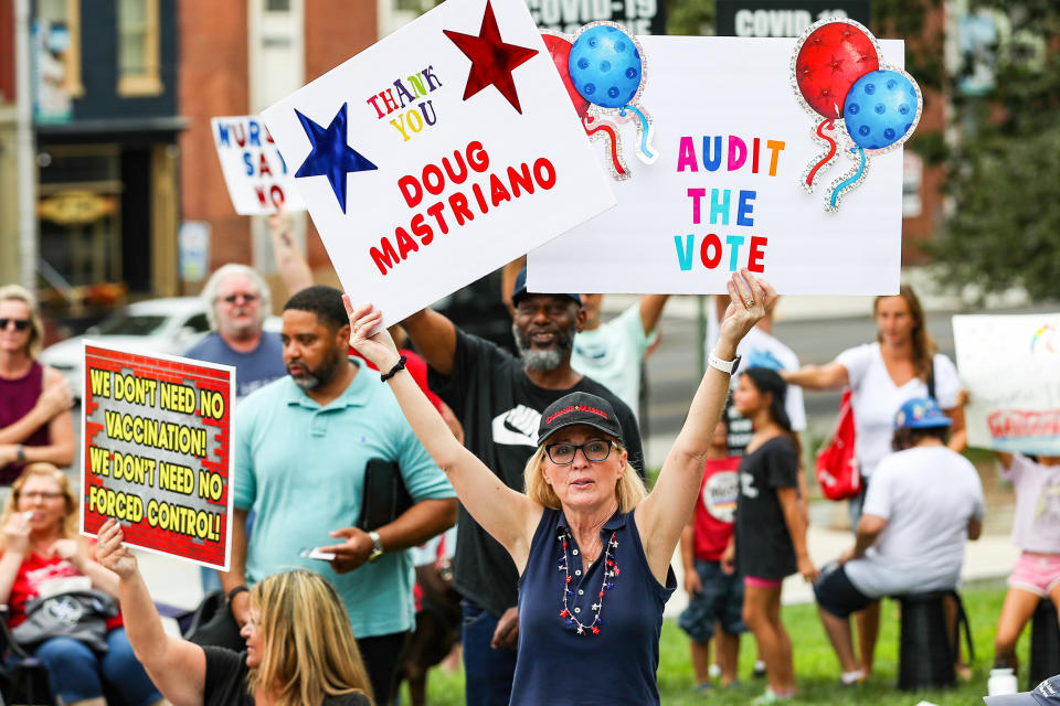 A protester holds placards during the anti-vaccine, anti- (Paul Weaver / SOPA Images / LightRocket via Getty Images file)