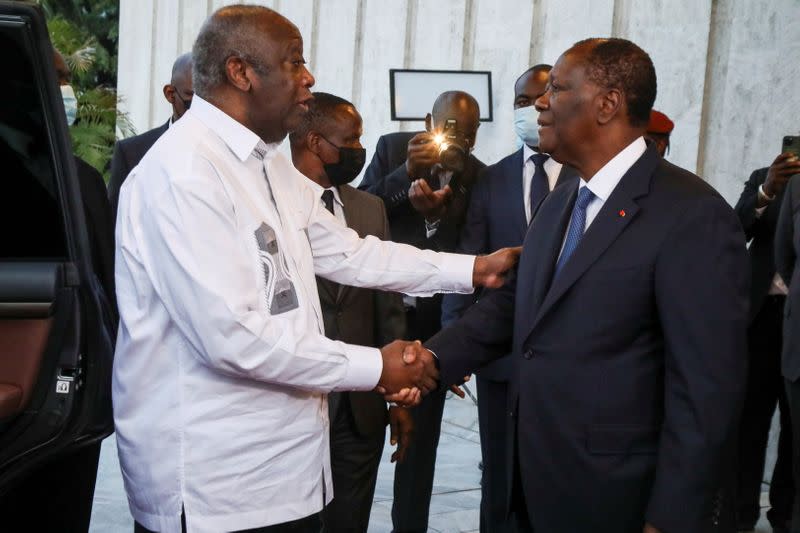 Ivory Coast's President Alassane Ouattara meets former President Laurent Gbagbo during a meeting at the presidential palace in Abidjan