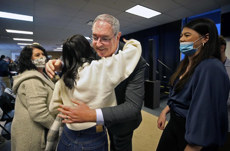 Joe Moorhead, the new new head coach of the Akron Zips football team, hugs his family after his introductory press conference at InfoCision Stadium on Thursday.