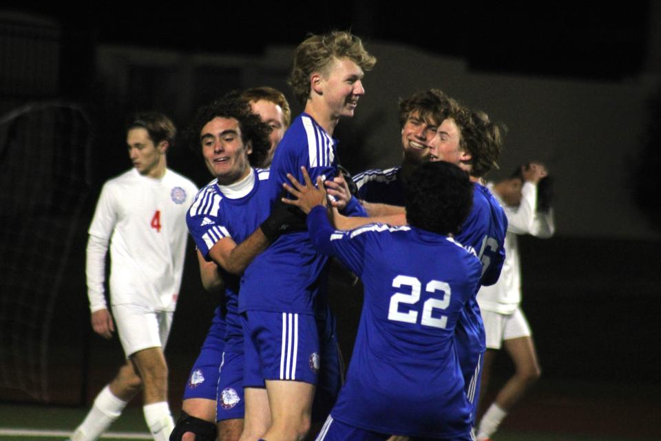 Bolles teammates celebrate with forward Jackson Geist (2, center) after his second goal against Wolfson.