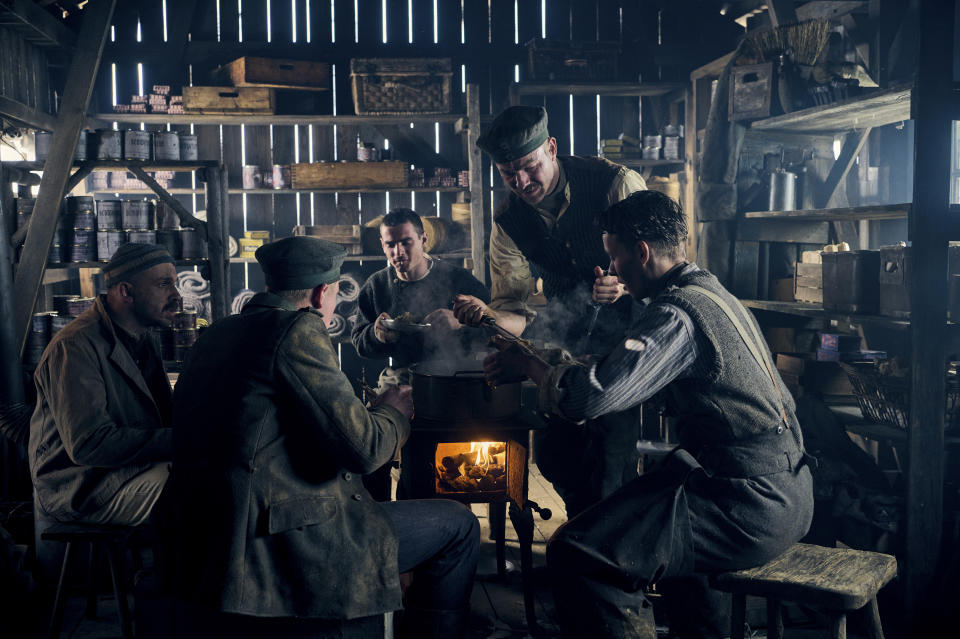 This image provided by Netflix shows Edin Hasanovic, from left, Aaron Hilmer, Albrecht Schuch and Felix Kammerera in a scene from "All Quiet on the Western Front." (Reiner Bajo/Netflix via AP)