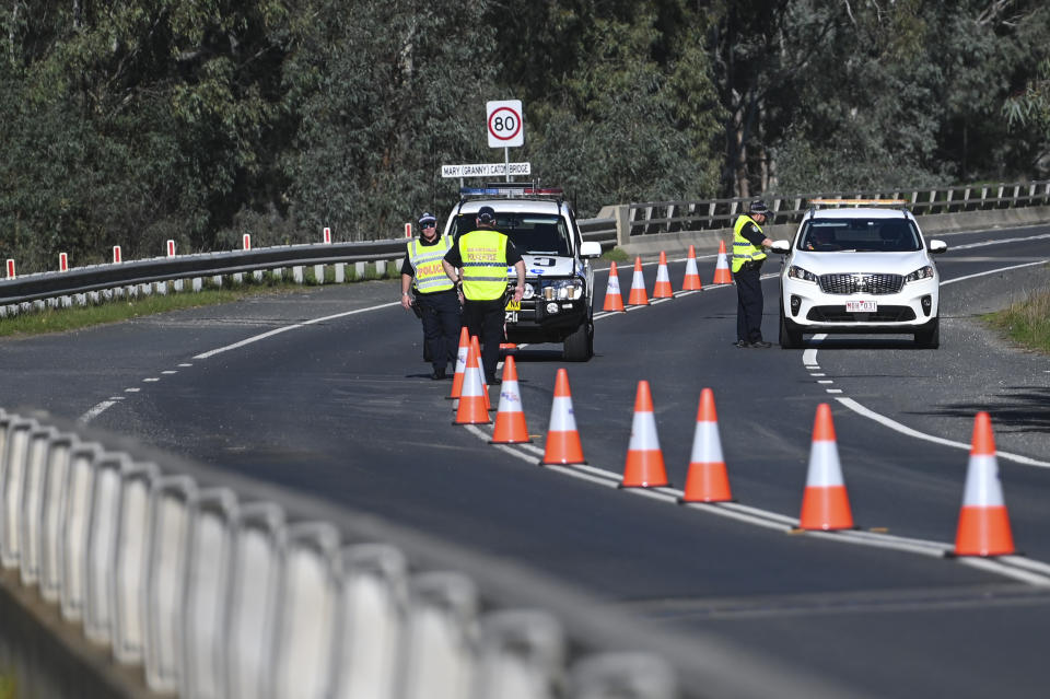 NSW Police officers are seen at the NSW-Victoria border crossing in Howlong near Albury.