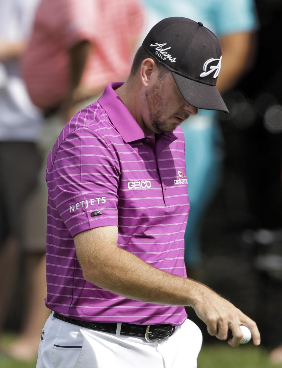 Robert Garrigus walks off the fifth green during the final round of the Valspar Championship golf tournament at Innisbrook, Sunday, March 16, 2014, in Palm Harbor, Fla. Garrigus finished tied for fourth. (AP Photo/Chris O'Meara)