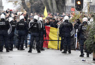 Riot police officers deployed to block the street during a protest against coronavirus measures in Brussels, Belgium, Sunday, Dec. 5, 2021. Hundreds of people marched through central Brussels on Sunday to protest tightened COVID-19 restrictions imposed by the Belgian government to counter the latest spike in coronavirus cases. (AP Photo/Geert Vanden Wijngaert)