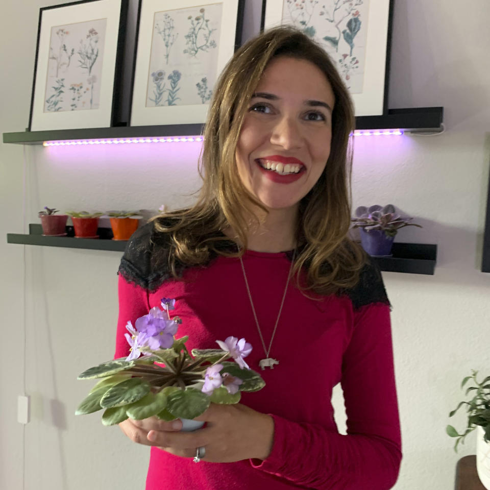 This undated photo, provided by Ana Carlson of Sill Appeal, shows Carlson holding a variegated African violet in Santa Monica, Calif. Carlson owns Sill Appeal, an online store selling plant décor, and regularly posts houseplant photos on Instagram. (Sill Appeal via AP)