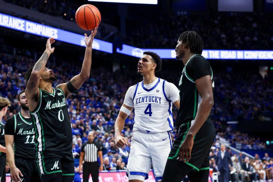 Kentucky’s Tre Mitchell (4) celebrates scoring a basket against Marshall’s Kevon Voyles (0) during Friday’s game at Rupp Arena. Mitchell finished with 18 points, four rebounds and four assists.