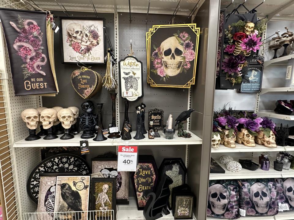 Black, purple, and skeleton decor in the aisle of a Michaels