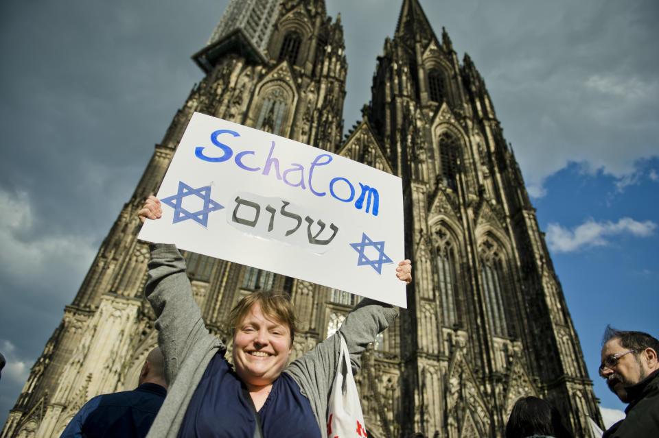 Activists holding a sign&nbsp;during a rally in front of Cologne Cathedral on April 25, 2018, in Cologne, Germany.