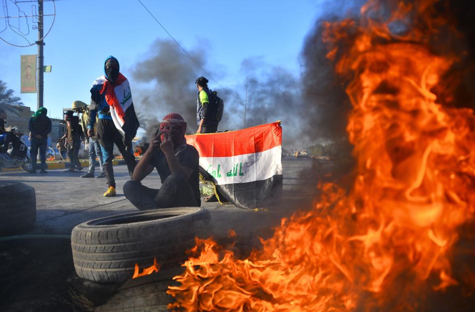 Iraqi demonstrators block a road with burning tyres in the central shrine city of Najaf, on January 5, 2020, to protest turning the country into an arena for US-Iran conflicts. - Iraq's parliament was expected to vote today on ousting thousands of US troops from military bases, which are threatened by pro-Tehran factions after an American strike killed top Iranian and Iraqi commanders. (Photo by Haidar HAMDANI / AFP) (Photo by HAIDAR HAMDANI/AFP via Getty Images)