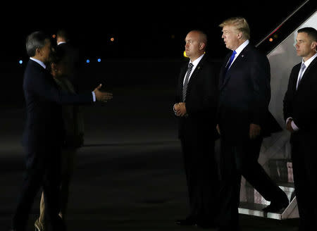 U.S. President Donald Trump is greeted by Singapore's Foreign Minister Vivian Balakrishnan after arriving in Singapore June 10, 2018. REUTERS/Jonathan Ernst