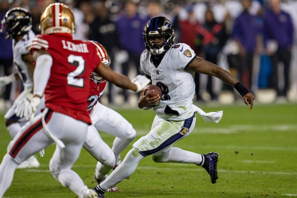 Dec 25, 2023; Santa Clara, California, USA; Baltimore Ravens quarterback Lamar Jackson (8) scrambles with the football against San Francisco 49ers safety Ji'Ayir Brown (27) during the second quarter at Levi's Stadium. Mandatory Credit: Neville E. Guard-USA TODAY Sports