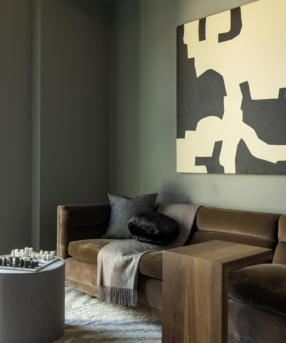 Green walls, brown velvet sofa