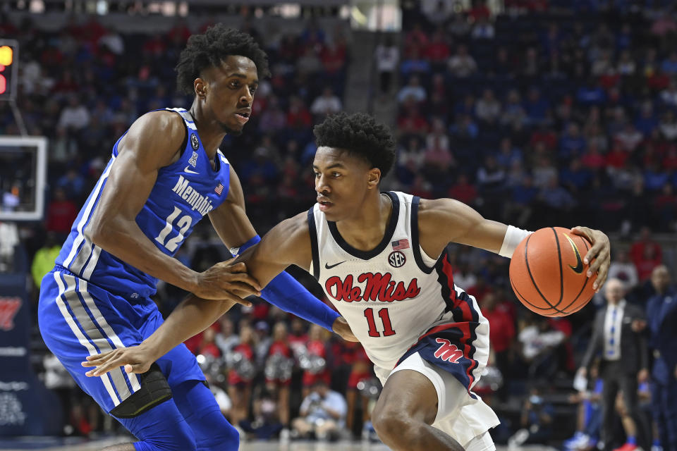 Mississippi guard Matthew Murrell (11) drives the ball past Memphis forward DeAndre Williams (12) during the second half of an NCAA college basketball game in Oxford, Miss., Saturday, Dec. 4, 2021. Mississippi won 67-63. (AP Photo/Thomas Graning)