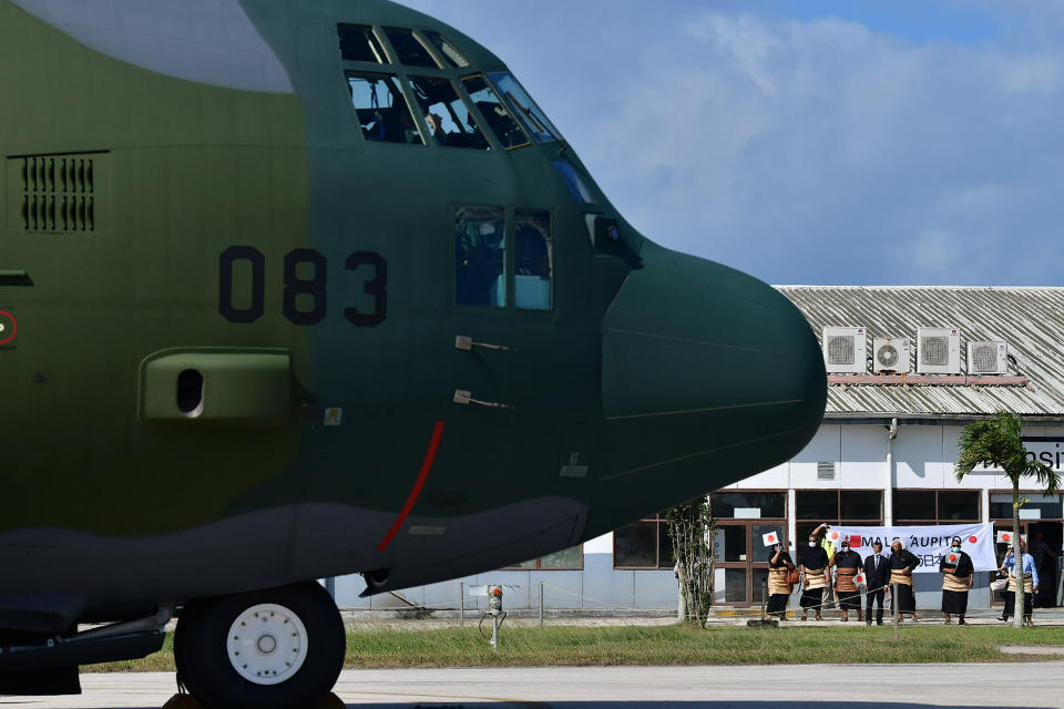 In this photo provided by Japan Joint Staff Office, a Japan Air Self-Defense Force aircraft sits on the tarmac at Tonga's Fua'amotu International Airport, near Nuku'alofa, Saturday, Jan. 22, 2022 to deliver aid after an undersea volcano eruption. (Japan Joint Staff Office via AP)