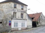 The run-down cafe "Au Paradis" (in Heaven"), its sign and paintwork faded over time. (Reuters)