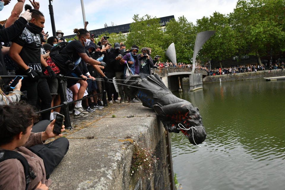 Protesters throw statue of Edward Colston into Bristol harbour during a Black Lives Matter protest rally, in memory of George Floyd who was killed on May 25 while in police custody in the US city of Minneapolis.