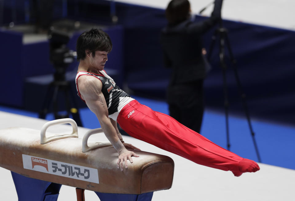 Kohei Uchimura of Japan competes in the pommel horse during an international gymnastics meet in Tokyo on Sunday, Nov. 8, 2020. Three-time Olympic gold-medal gymnast Uchimura wants the postponed Tokyo Olympics to happen in just under nine months. But he's also talked openly about the skepticism in Japan where enthusiasm is muted by health risks, billions of dollars in taxpayer bills, and questions why the Games are a priority amid a pandemic. (AP Photo/Hiro Komae)