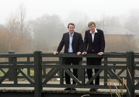 File photo of David Cameron (L), leader of Britain's Conservative Party, speaking to the then-editor of the Ecologist magazine, Zac Goldsmith, on a bridge at the London Wetlands Centre in Barnes, London December 9, 2005. REUTERS/Stephen Hird