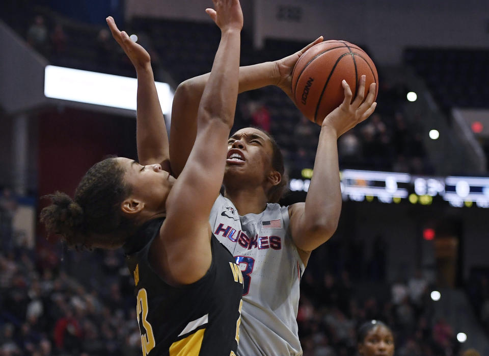 Connecticut's Megan Walker, right, shoots as Wichita State's Seraphine Bastin defends during the first half of an NCAA college basketball game Thursday, Jan. 2, 2020, in Hartford, Conn. (AP Photo/Jessica Hill)