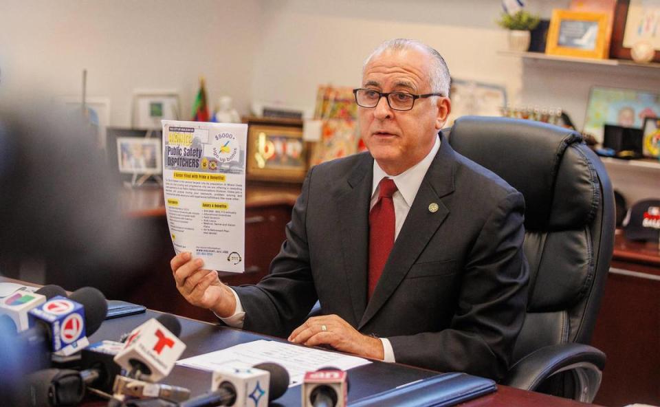 City of Hialeah Mayor Esteban Bovo, Jr. holds up a job ad as he speaks about the 911 emergency department during a press conference at City Hall, Thursday, August 10, 2023.