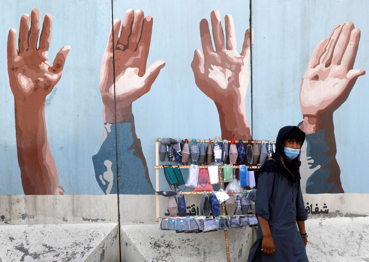 An Afghan man sells protective face masks during the coronavirus disease (COVID-19) outbreak in Kabul, Afghanistan June 18, 2020. REUTERS/Mohammad Ismail     TPX IMAGES OF THE DAY