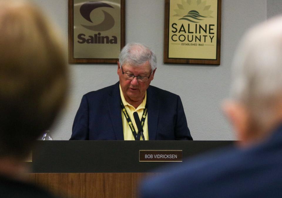 Saline County Commission Chair Bob Vidricksen reads a proposal during the Sept. 12 County Commission meeting.
