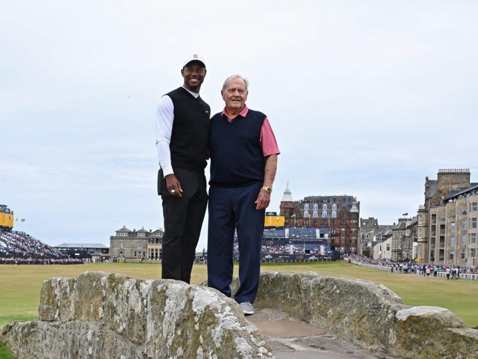 Open winners Woods (left) and Jack Nicklaus on the Swilcan Bridge at the iconic Old Course  (AFP via Getty Images)