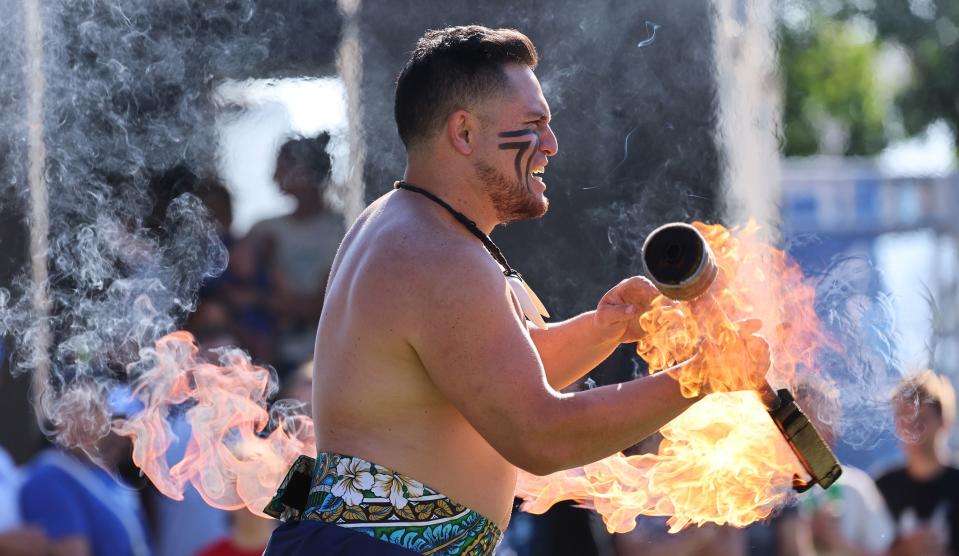 Fire Knife Dancer Lasi Reed spins his torch as his group performs as BYU holds a party to celebrate their move into the Big 12 Conference with music, games and sports exhibits in Provo on Saturday, July 1, 2023. | Scott G Winterton, Deseret News