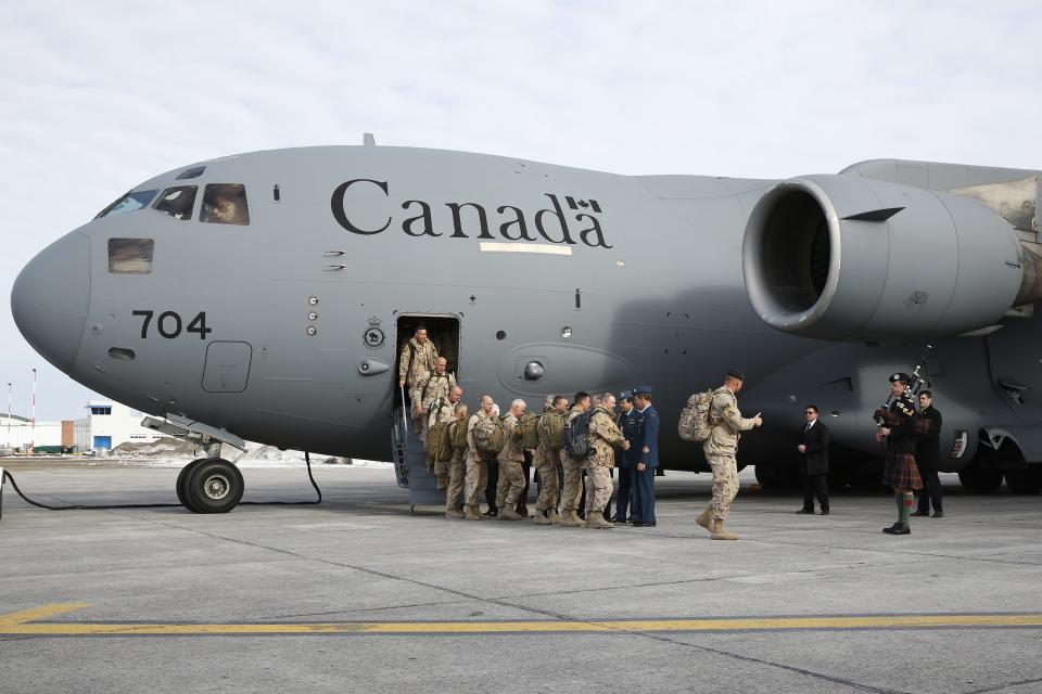The last Canadian soldiers returning from Afghanistan are greeted by dignitaries as they deplane in Ottawa