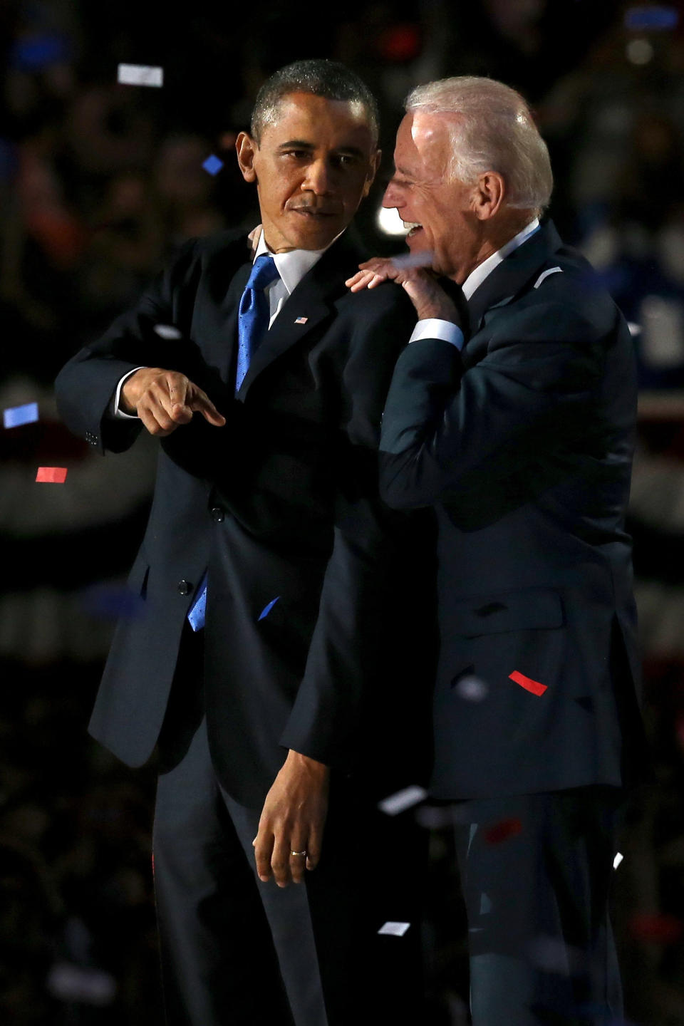 President Barack Obama hugs Vice President Joe Biden as his daughter Malia and Sasha look on at his election night party Wednesday, Nov. 7, 2012, in Chicago. President Obama defeated Republican challenger former Massachusetts Gov. Mitt Romney. 