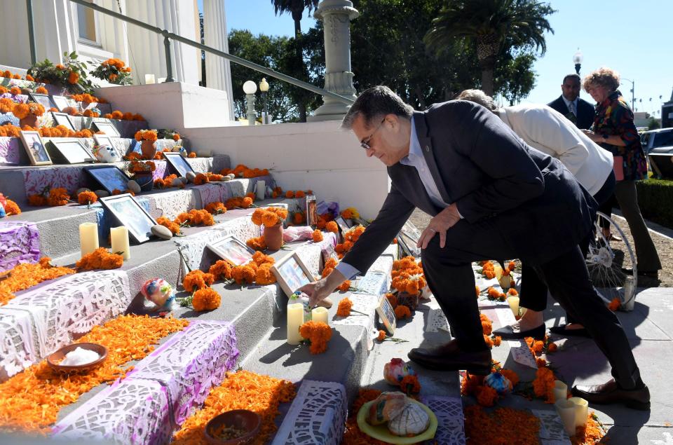 Xavier Becerra, secretary of U.S. Health and Human Services, put a sugar skull next to a photo of the late Ventura County Supervisor Carmen Ramirez at a memorial in November 2022.