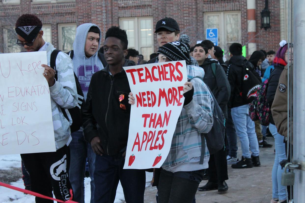 A South High School student holds up a sign Monday to support teachers' demand for better pay. Denver Public Schools teachers went on strike for the first time 25 years.