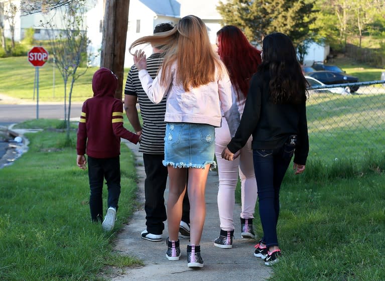 MD., APRIL 16, 2020: Jose C. and his kids, who were just released after being stuck for months in a government shelter, takes a rare walk to the corner amid shelter-in-place orders. (Kirk McKoy / Los Angles Times)