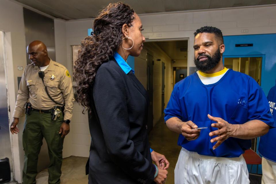 Retired Judge Songhai Armstead talks with Craigen Armstrong.