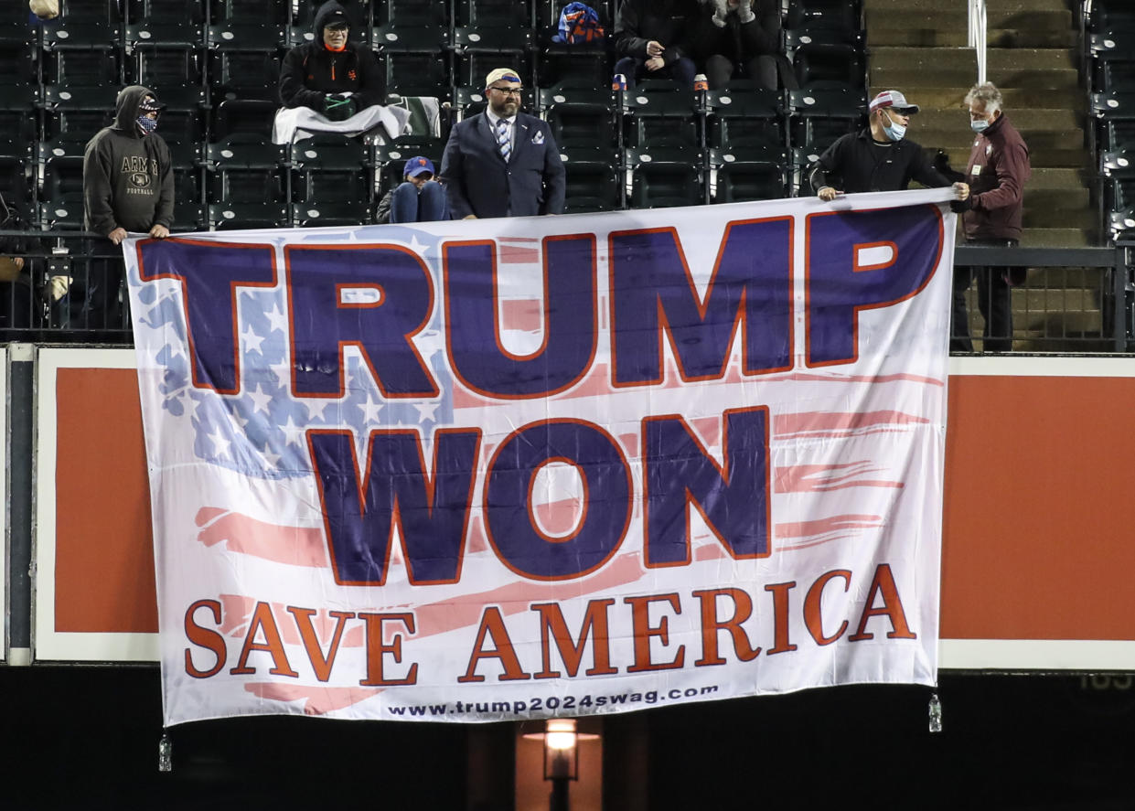 A banner that reads Trump Won, Save America is unfurled during a baseball game.