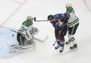 Colorado Avalanche's Nathan MacKinnon (29) scores against Dallas Stars goalie Anton Khudobin (35) as Stars' Miro Heiskanen (4) defends during second-period NHL Western Conference Stanley Cup playoff hockey game action in Edmonton, Alberta, Saturday, Aug. 22, 2020. (Jason Franson/The Canadian Press via AP)