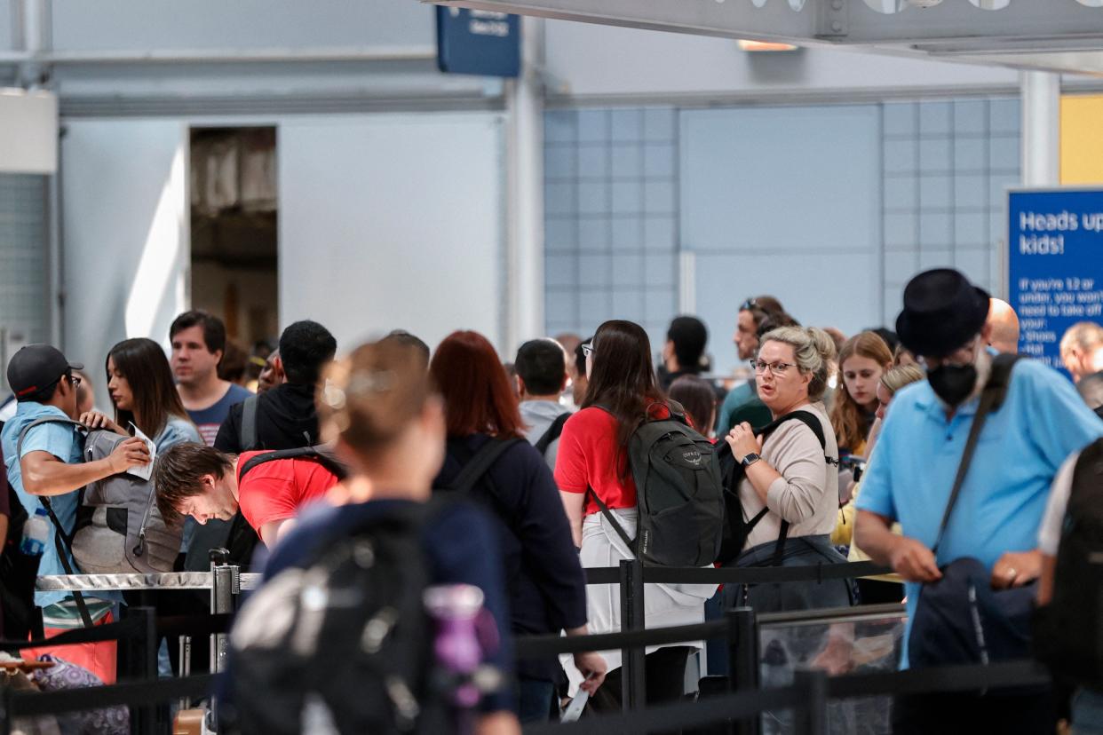 Travelers wait in line at O'Hare International Airport on June 30, 2022, in Chicago.
