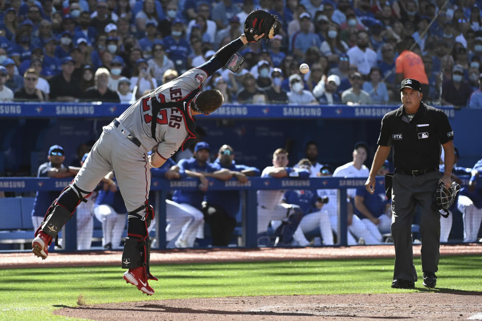 Minnesota Twins catcher Ryan Jeffers misses catching a pop-up fly ball off the bat of Toronto Blue Jays' George Springer in the first inning of a baseball game in Toronto on Saturday, Sept. 18, 2021. (Jon Blacker/The Canadian Press via AP)