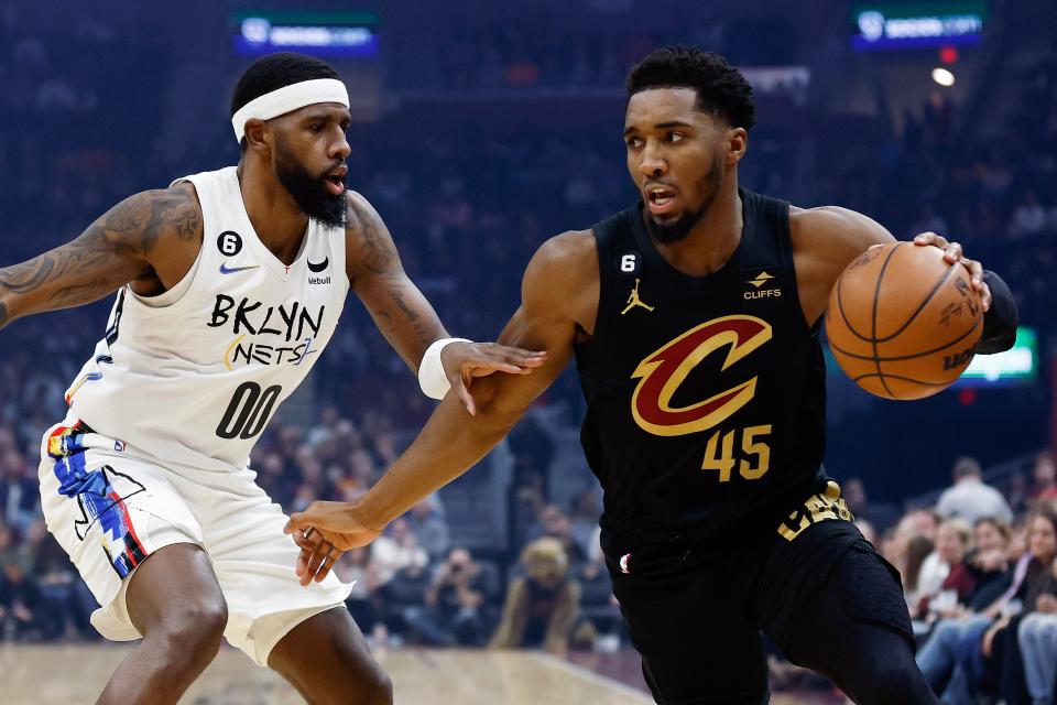Cavaliers guard Donovan Mitchell drives against Brooklyn Nets forward Royce O'Neale during the first half, Monday, Dec. 26, 2022, in Cleveland.