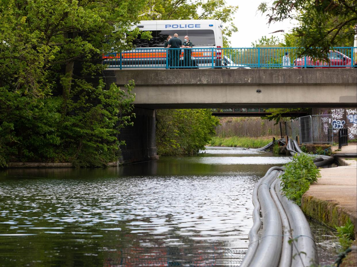 <p>Police officers on scene at the Grand Union Canal near Old Oak Lane in northwest London.</p> (PA)