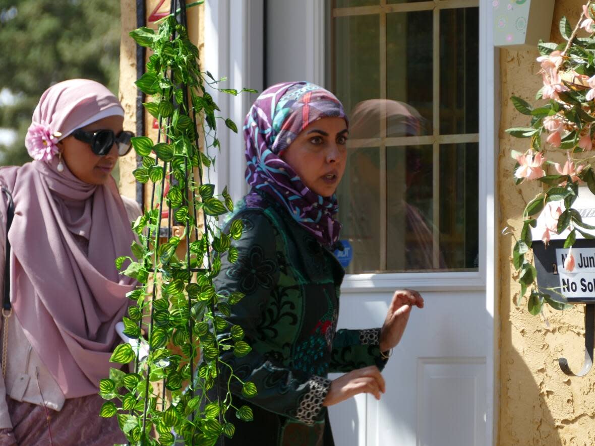 Zarqa Nawaz (right) is on set the set of her show ZARQA on Tuesday near Candy Cane Park in Regina.  (Cory Herperger/Radio-Canada - image credit)