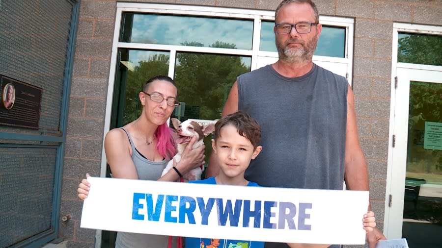 Family holding dog.