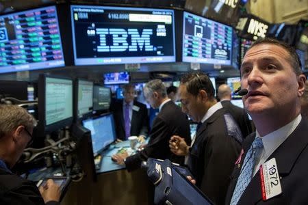 Traders gather at the post that trades IBM on the floor of the New York Stock Exchange October 20, 2014. REUTERS/Brendan McDermid
