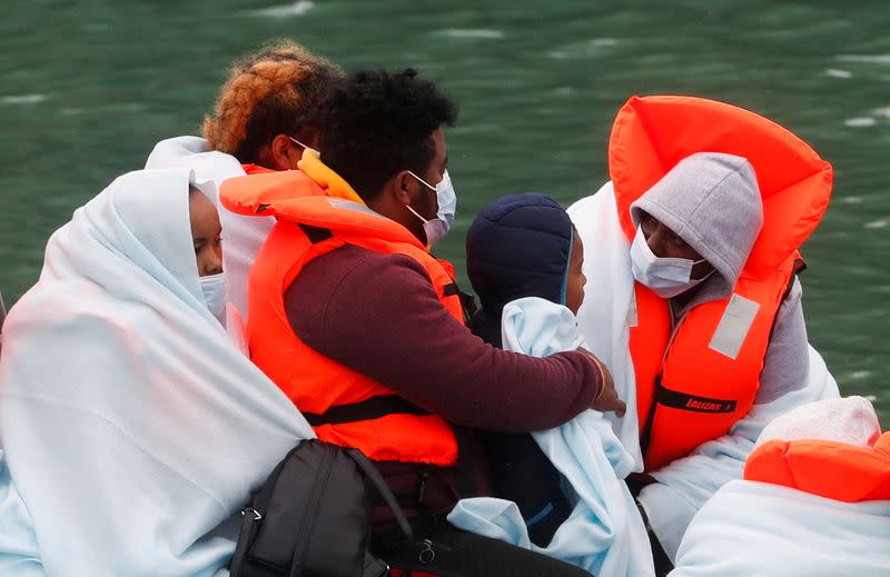 FILE PHOTO: Border Patrol agents bring migrants into Dover harbour on a boat, in Dover